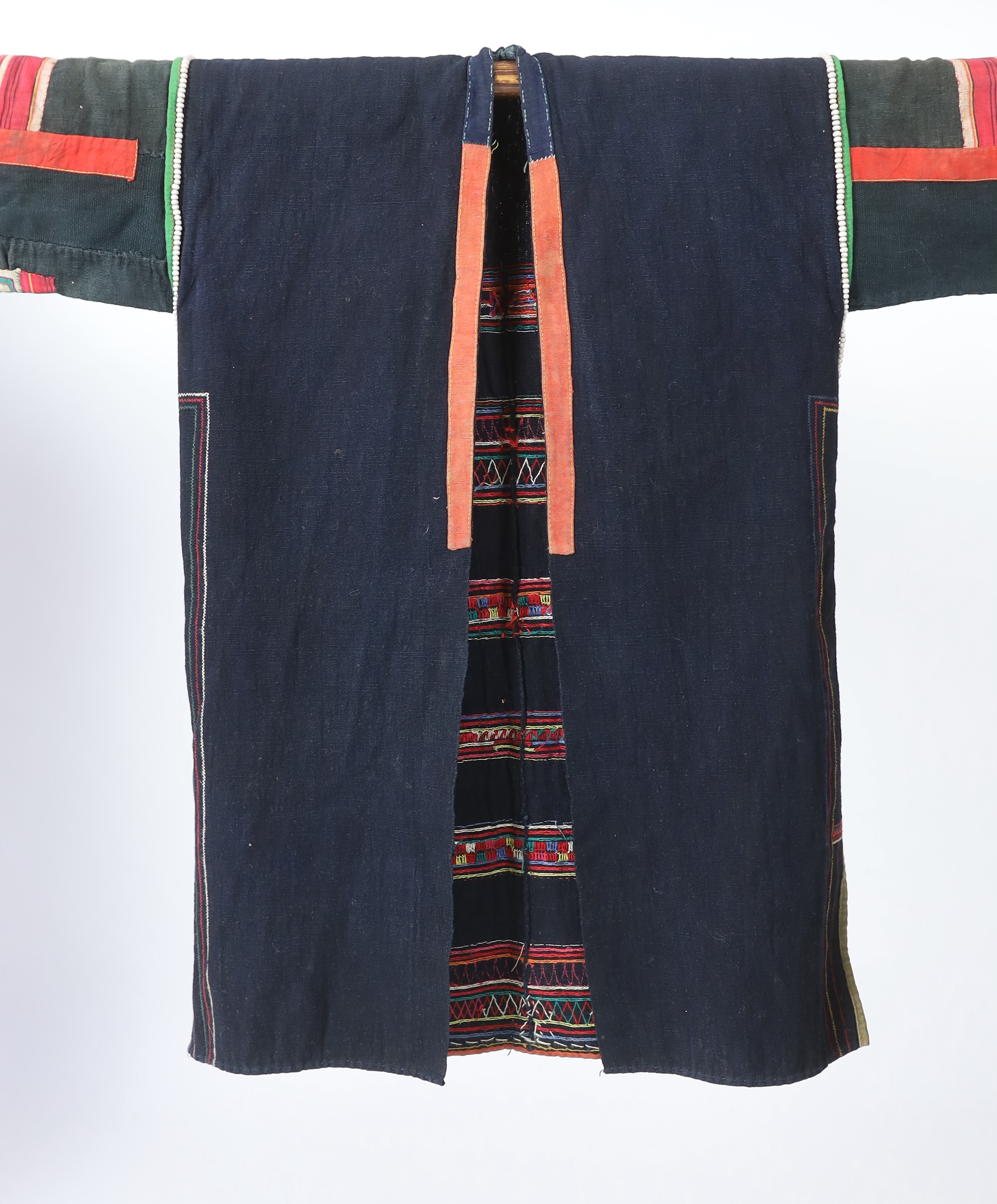 A Chiang Mai (Thailand) embroidered ladies three quarter length jacket, embroidered in hand dyed polychrome threads, (HKHA jacket) with beaded borders and spot design on a hand woven linen, 79cm long from neck to base